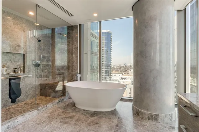 a spacious bathroom with a bathtub and shower