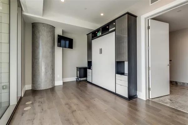 an empty room with wooden floor and white doors