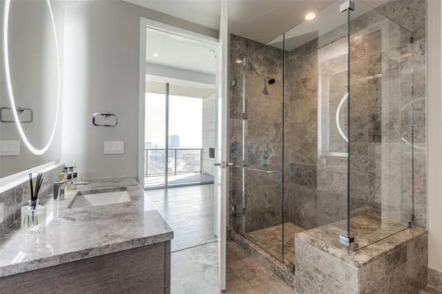 a bathroom with a shower sink and mirror