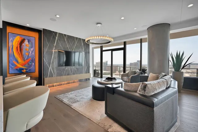 a living room with furniture tv and a large window