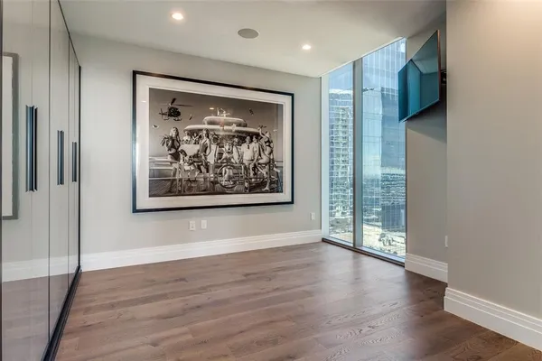 a view of a hallway with wooden floor and a large window