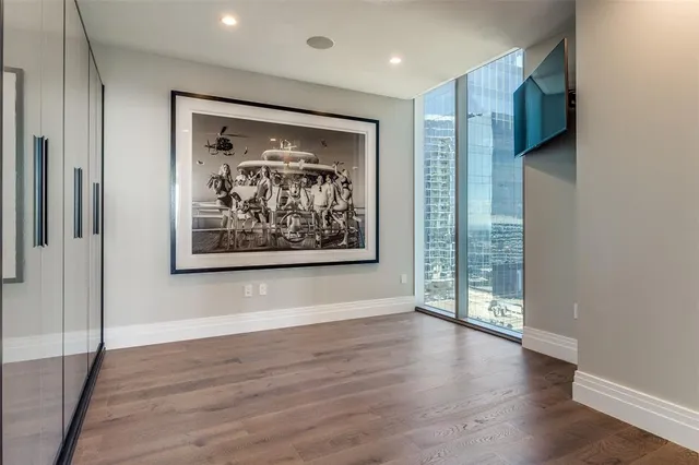 a view of a hallway with wooden floor and a large window