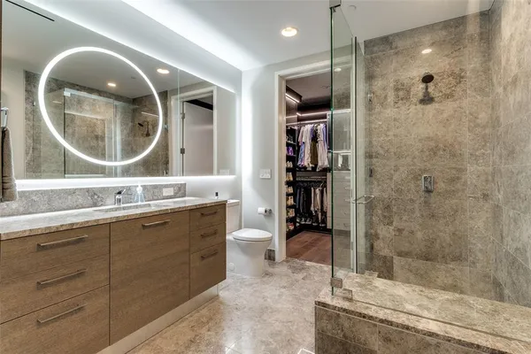 a bathroom with a double vanity sink mirror and shower