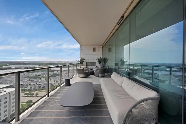 a view of balcony with couch and chairs
