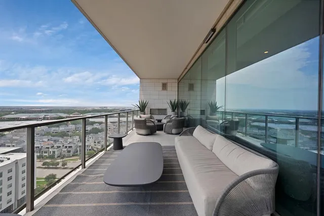 a view of balcony with couch and chairs