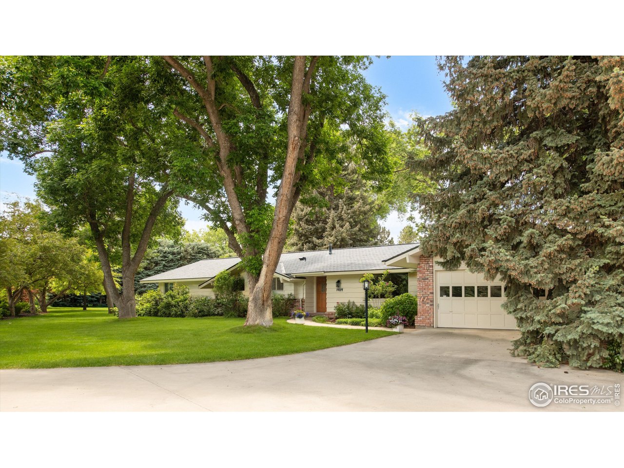 1409 Old Tale Road Boulder, CO 80303 - Photo 9 of 40 a front view of a house with a garden