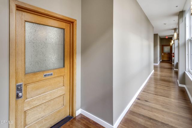 a view of a hallway with wooden floor