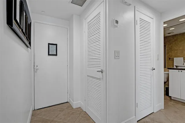 a view of a hallway with bathroom and entryway