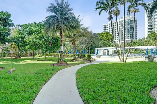 a view of a swimming pool with a garden and trees