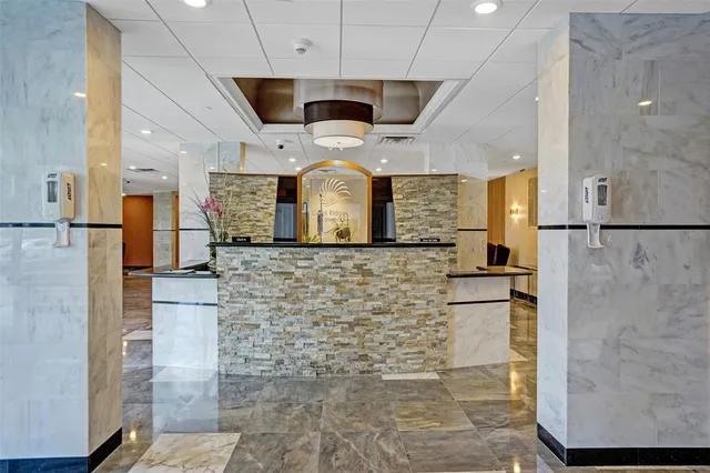 a living room with furniture and large windows