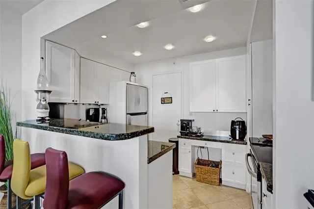 a kitchen with stainless steel appliances granite countertop a sink and cabinets