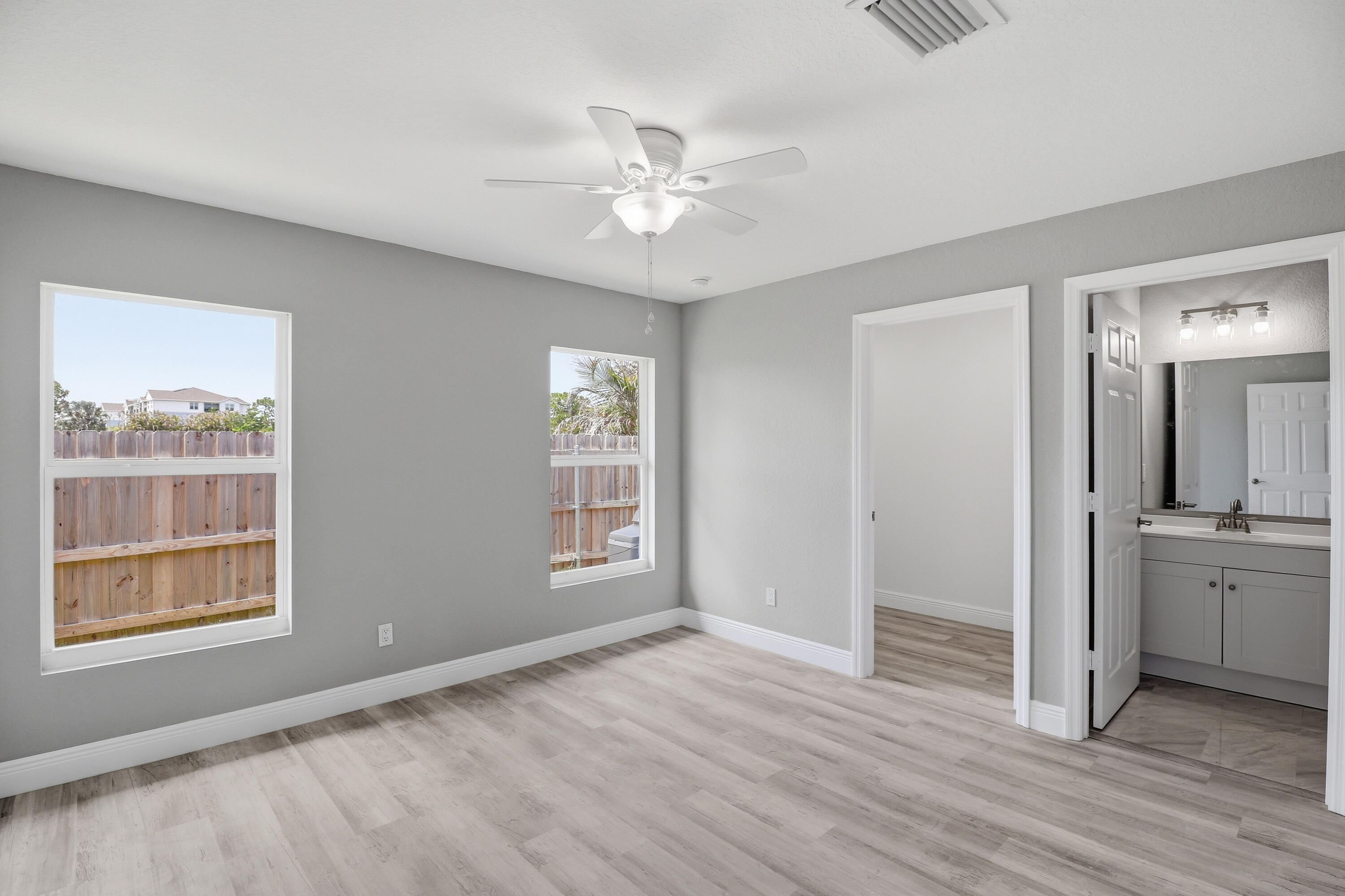 2805 Southeast Carroll Street Stuart, FL 34997 - Photo 9 of 21 a view of an empty room with a window and wooden floor