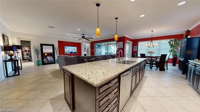 a kitchen with stainless steel appliances granite countertop a stove refrigerator and chairs