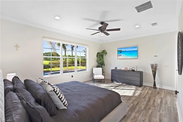 a living room with a bed furniture and paintings on the wall