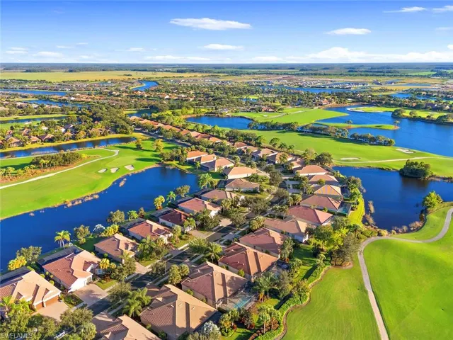 a front view of multiple houses with yard