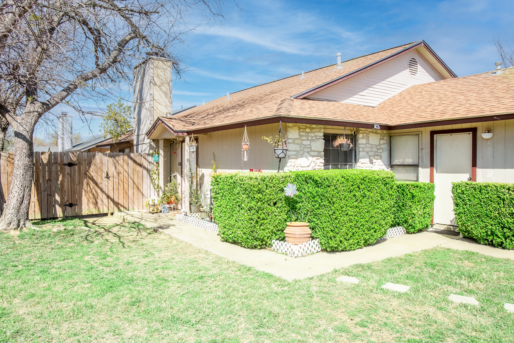 606 Misty Morning Way, Unit A AND B Round Rock, TX 78664 - Photo 2 of 22 View of property exterior with a shingled roof, a gate, and stone siding