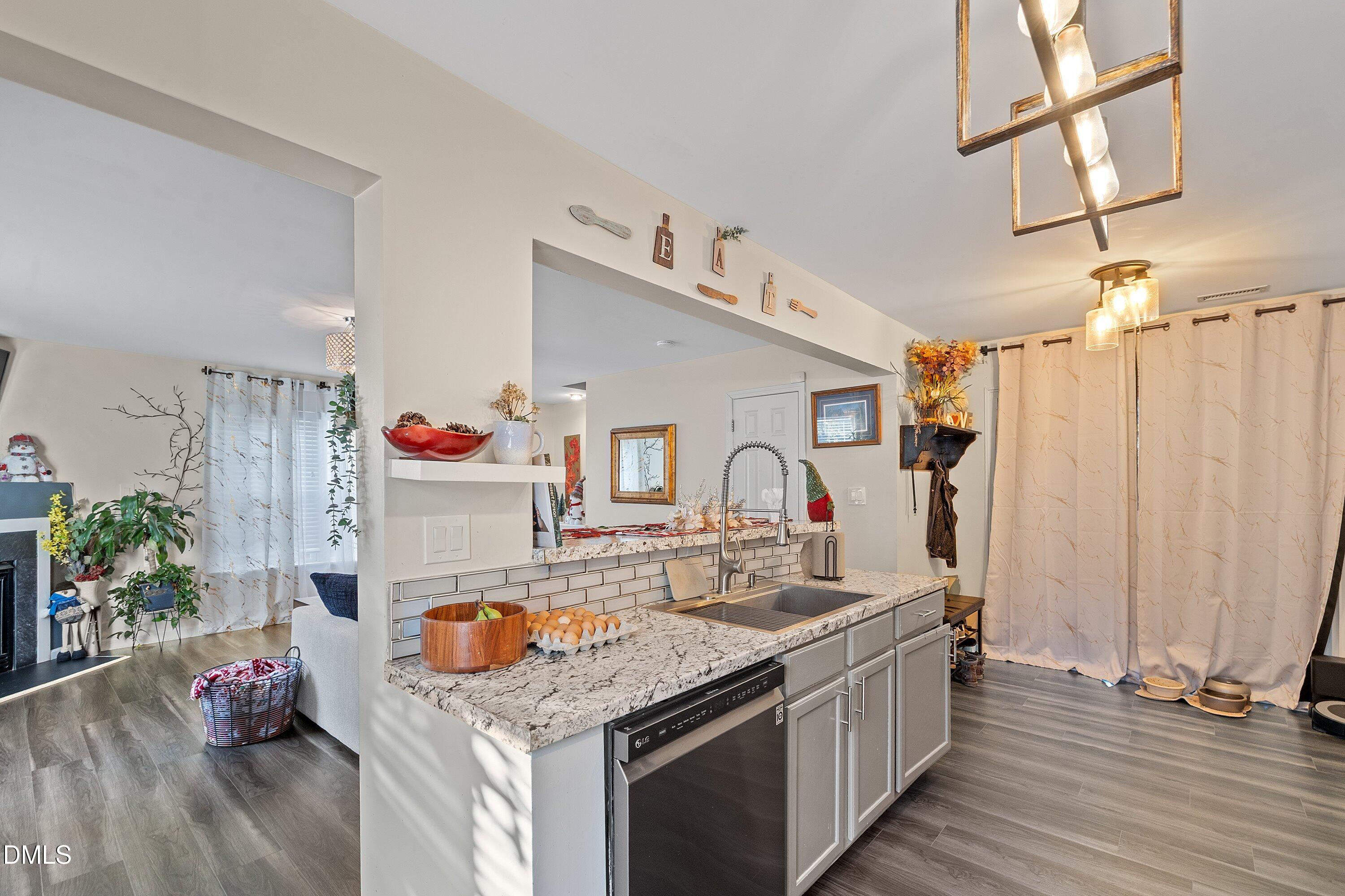 2027 Buffalo Way Durham, NC 27704 - Photo 13 of 30 a kitchen with a sink stove and wooden floor
