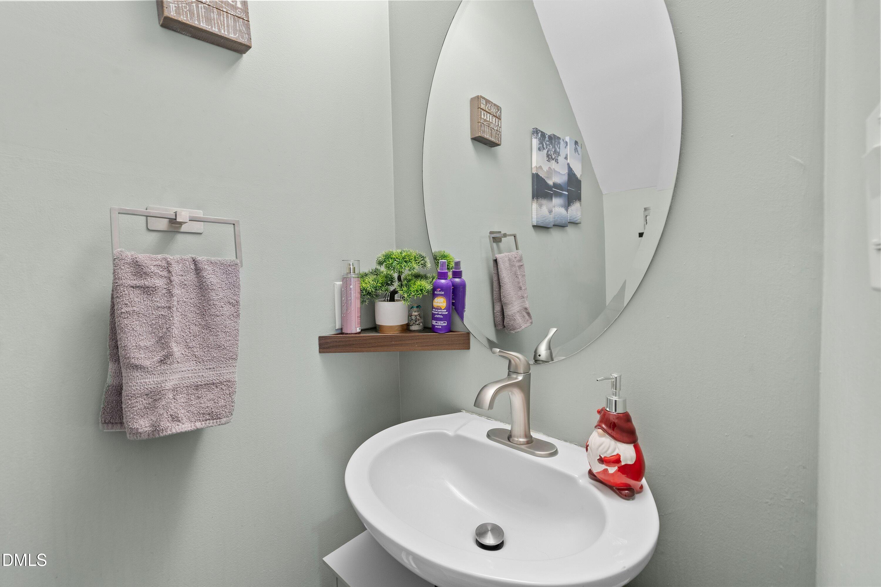 2027 Buffalo Way Durham, NC 27704 - Photo 17 of 30 a bathroom with a sink mirror and vanity
