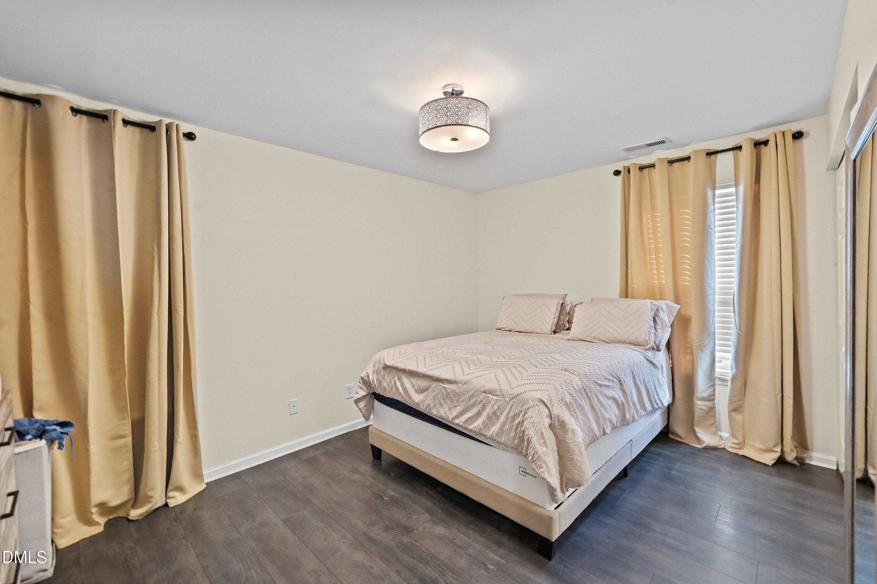 2027 Buffalo Way Durham, NC 27704 - Photo 20 of 30 a bedroom with a bed and a window