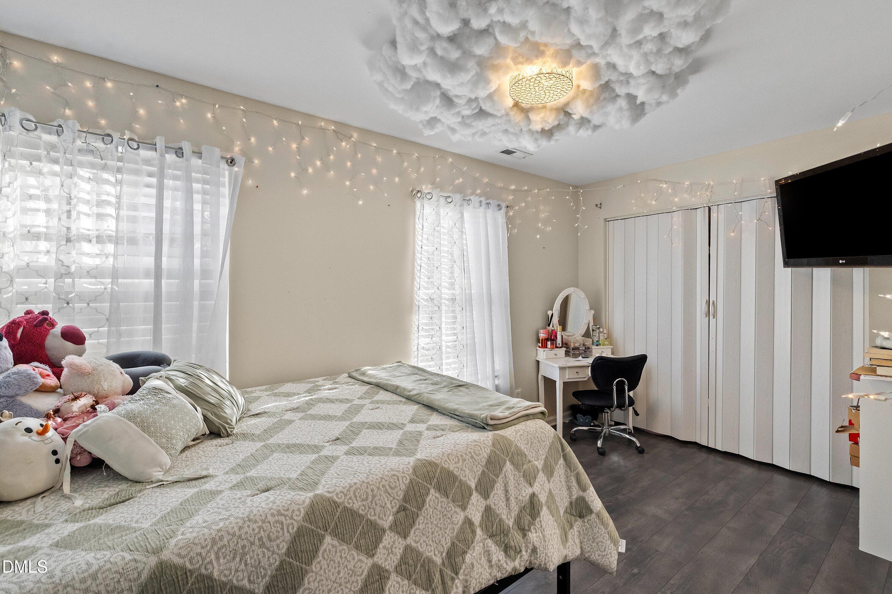 2027 Buffalo Way Durham, NC 27704 - Photo 22 of 30 a bedroom with a bed and a chandelier