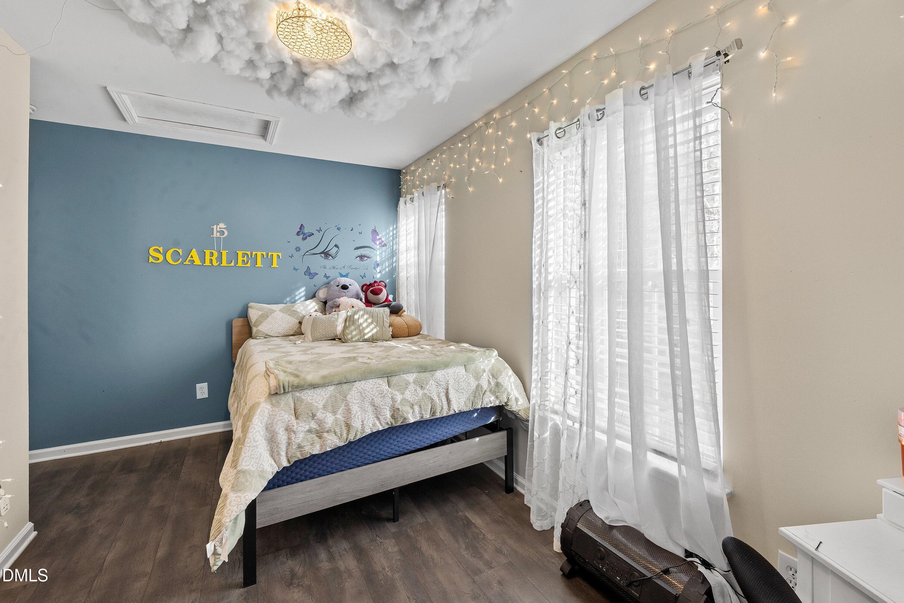 2027 Buffalo Way Durham, NC 27704 - Photo 23 of 30 a bedroom with a bed table and a window