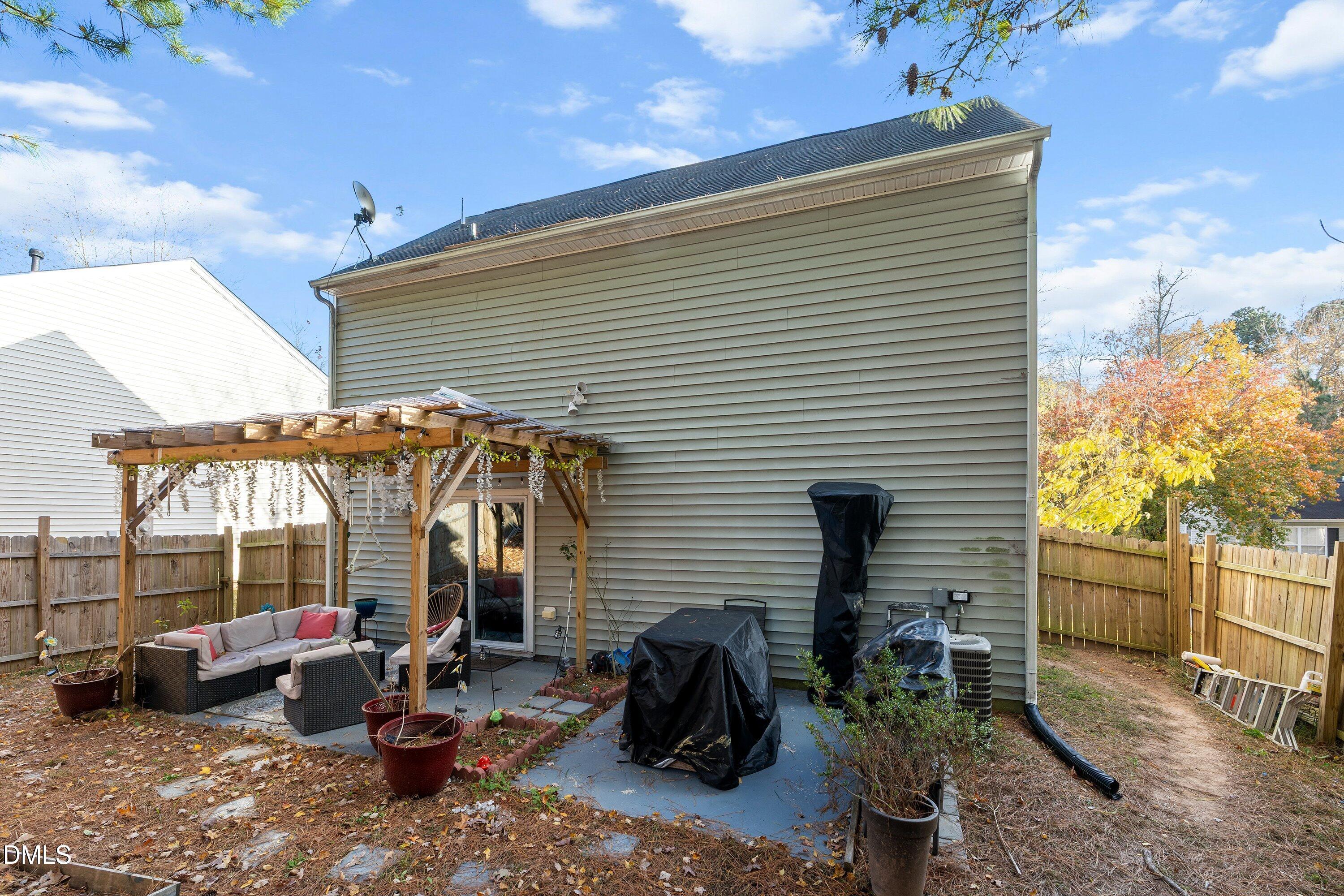 2027 Buffalo Way Durham, NC 27704 - Photo 26 of 30 a view of a patio with table and chairs potted plants