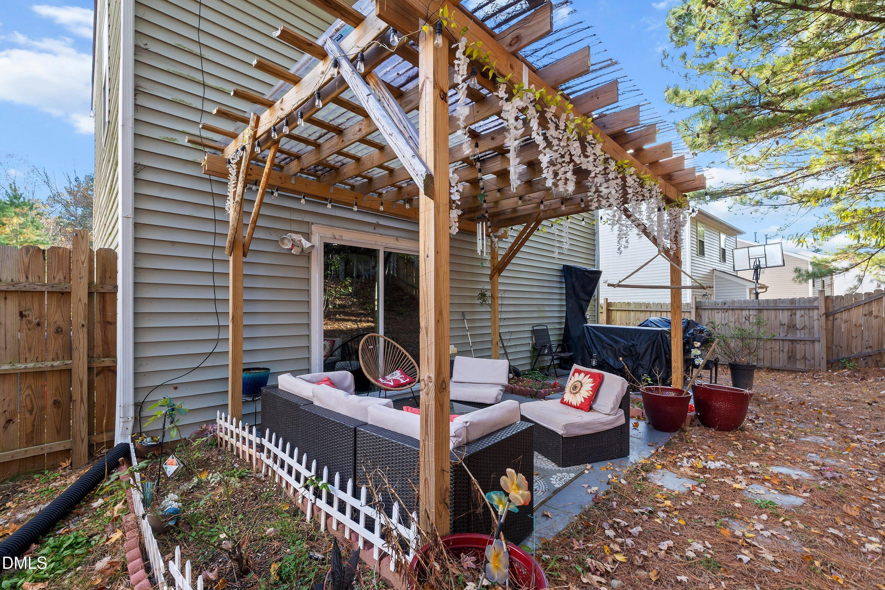 2027 Buffalo Way Durham, NC 27704 - Photo 28 of 30 a view of a patio with table and chairs and wooden fence