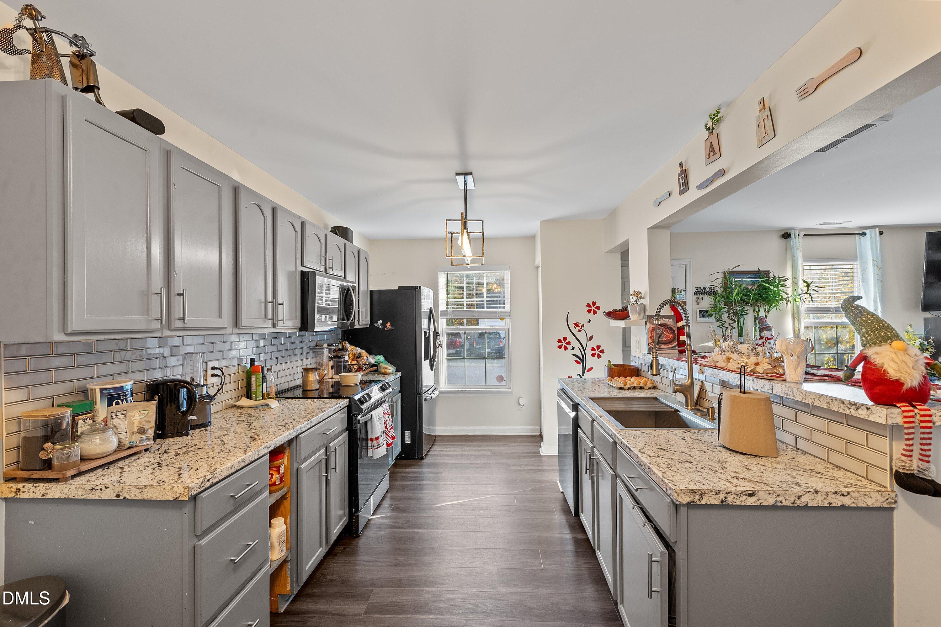 2027 Buffalo Way Durham, NC 27704 - Photo 9 of 30 a kitchen that has a lot of cabinets in it