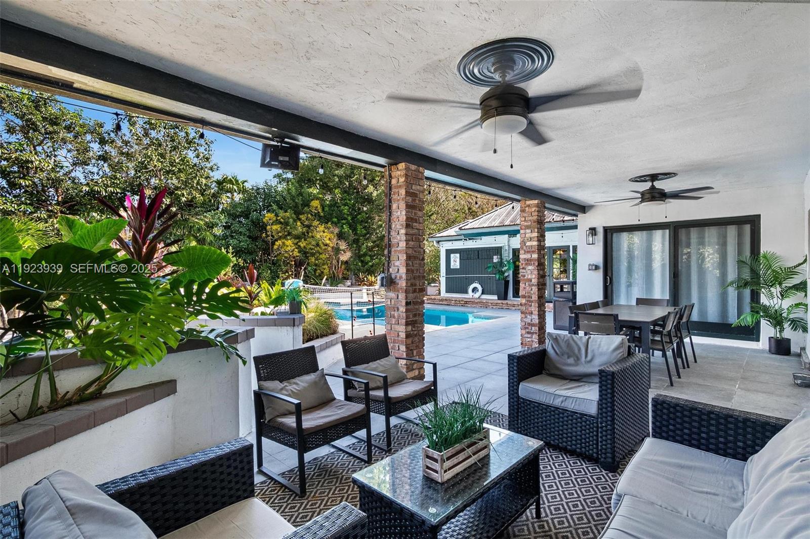 11155 Southwest 40th Street Davie, FL 33328 - Photo 12 of 74 a living room with patio furniture and a potted plant
