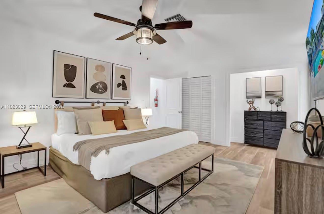 11155 Southwest 40th Street Davie, FL 33328 - Photo 14 of 100 a bedroom with a bed a dresser and a chandelier
