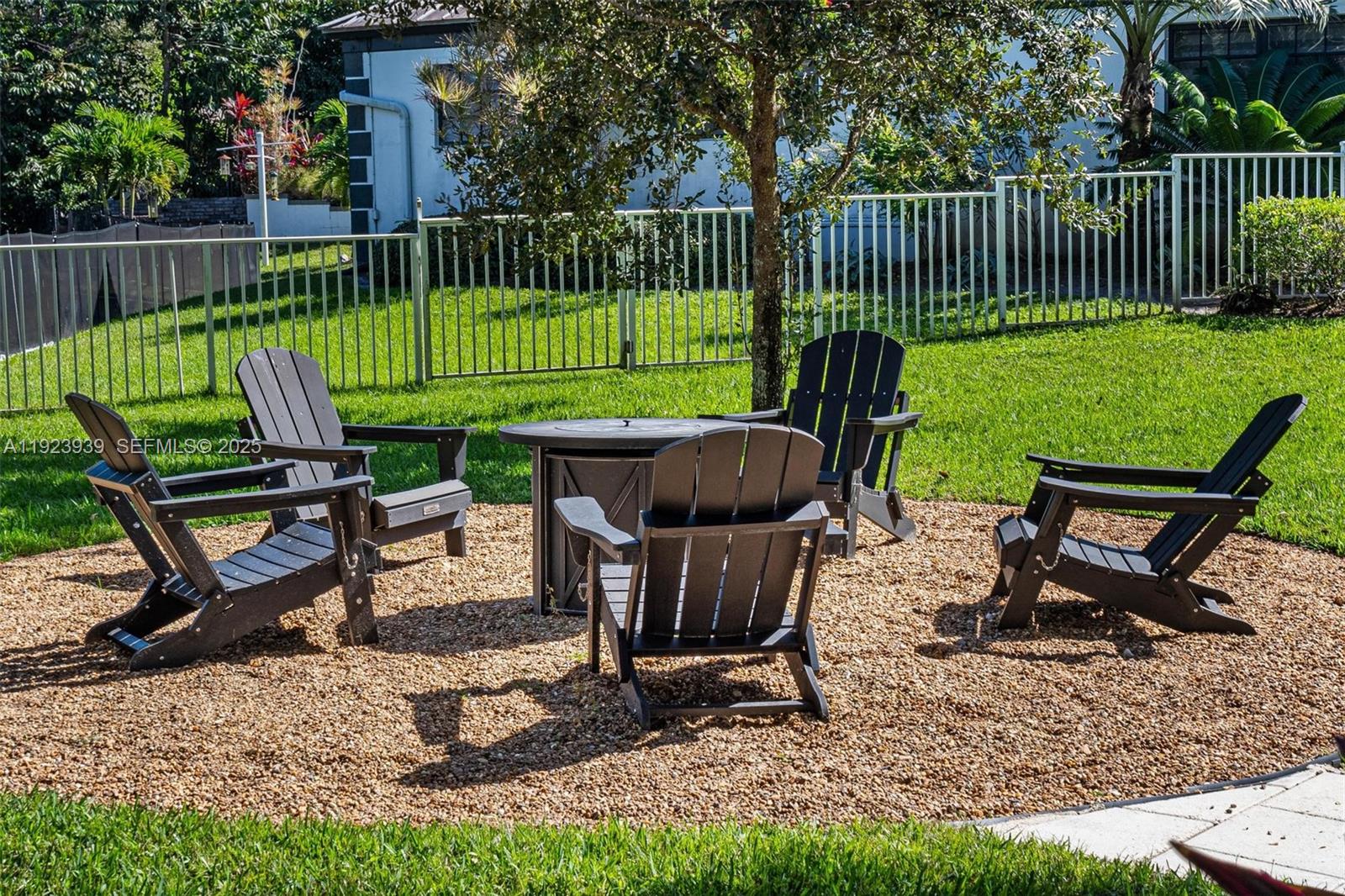 11155 Southwest 40th Street Davie, FL 33328 - Photo 15 of 74 a view of a chairs and backyard table and chair