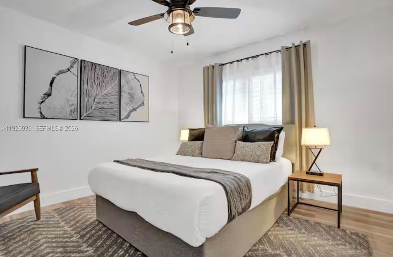 11155 Southwest 40th Street Davie, FL 33328 - Photo 16 of 100 a bedroom with a bed and a chandelier