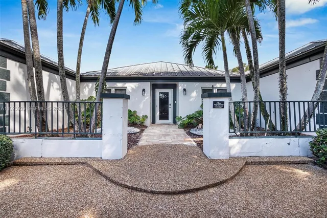 an aerial view of a house with a garden and lake view