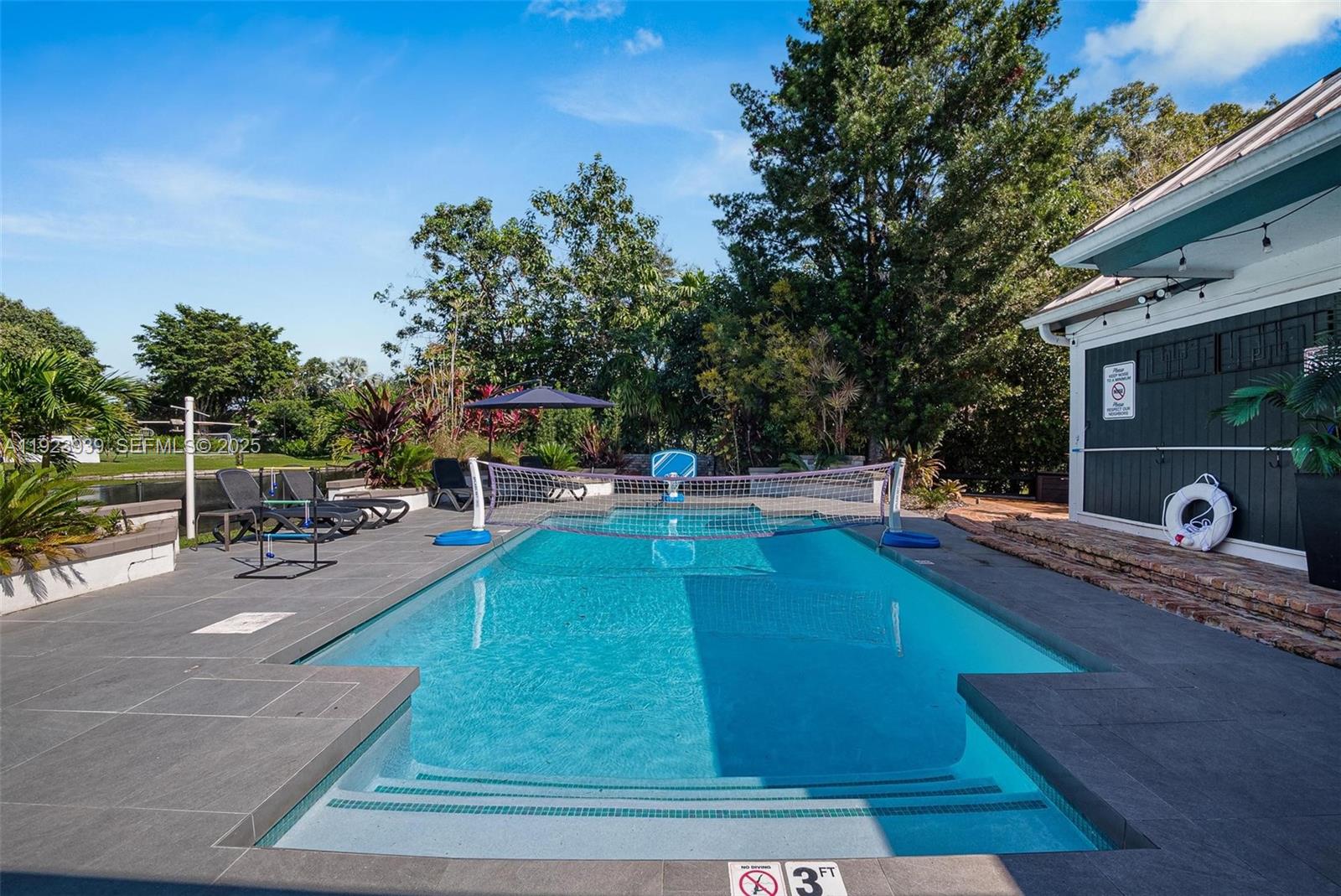 11155 Southwest 40th Street Davie, FL 33328 - Photo 25 of 74 a view of a swimming pool with chairs