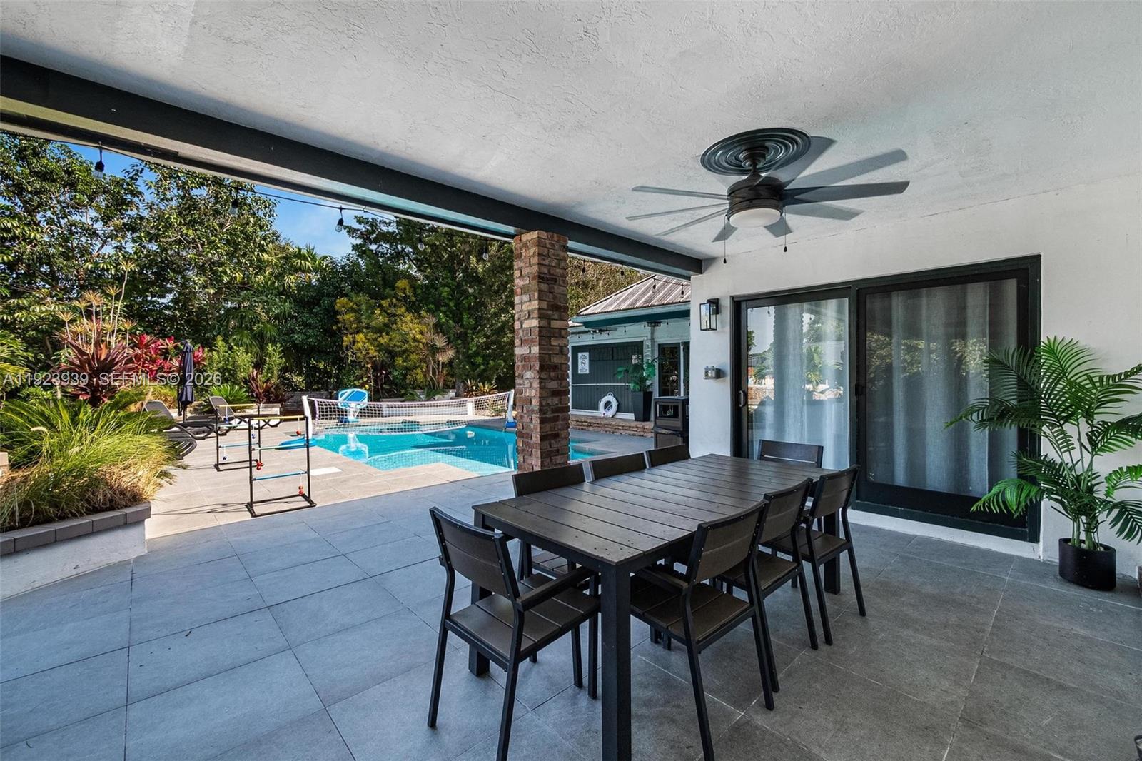 11155 Southwest 40th Street Davie, FL 33328 - Photo 30 of 100 a view of a patio with a table chairs and a backyard