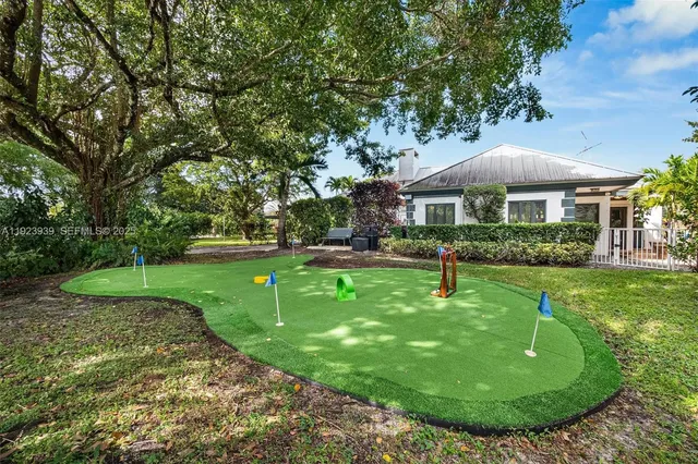 a front view of a house with a tree