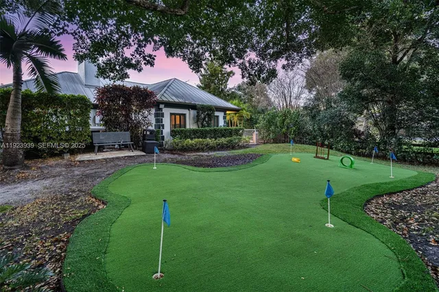 a backyard of a house with table and chairs