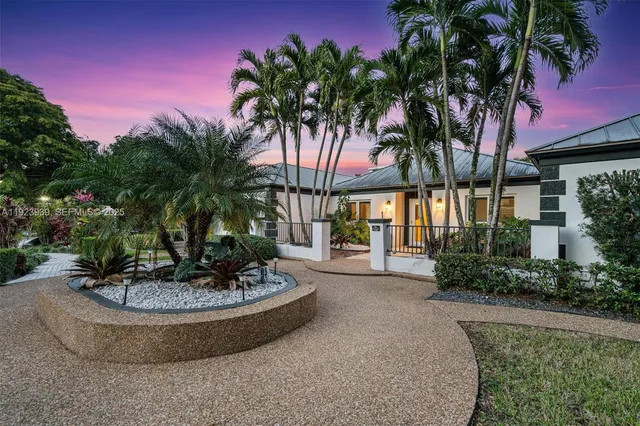 a view of a swimming pool with lawn chairs under an umbrella
