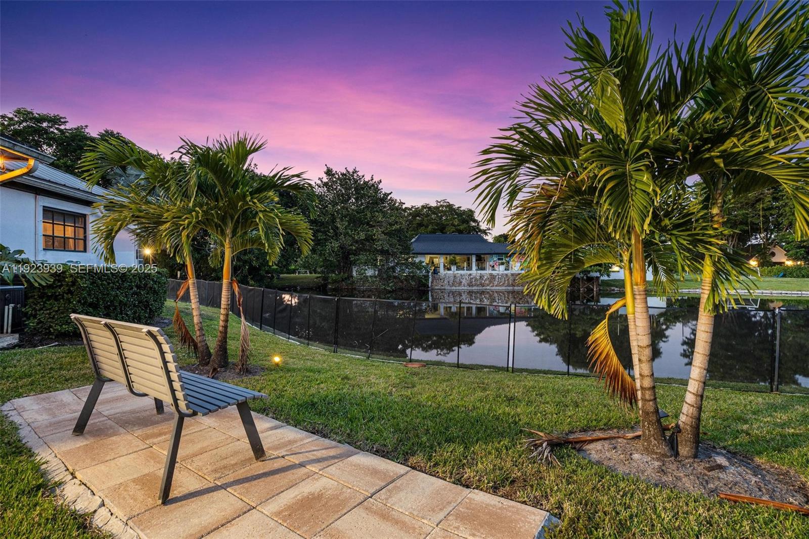 11155 Southwest 40th Street Davie, FL 33328 - Photo 47 of 74 a backyard of a house with table and chairs