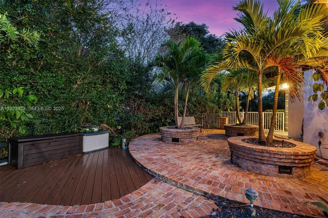 a view of a backyard with plants and patio