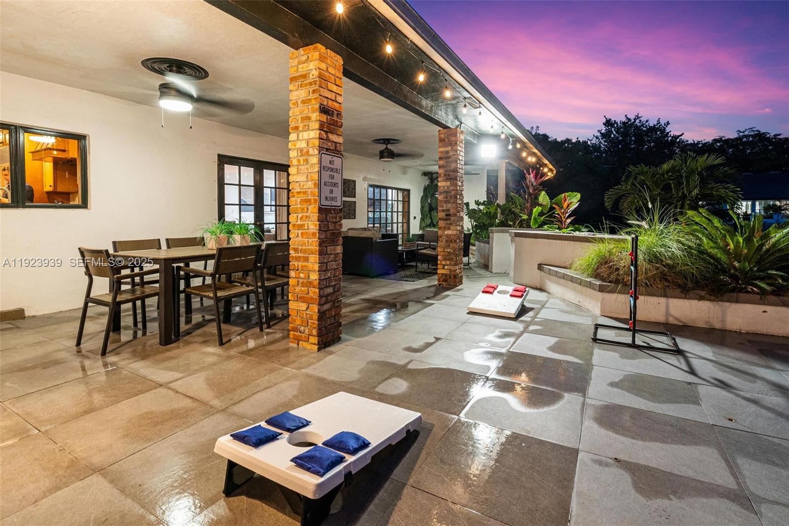 11155 Southwest 40th Street Davie, FL 33328 - Photo 57 of 74 a living room with furniture a rug and a potted plant