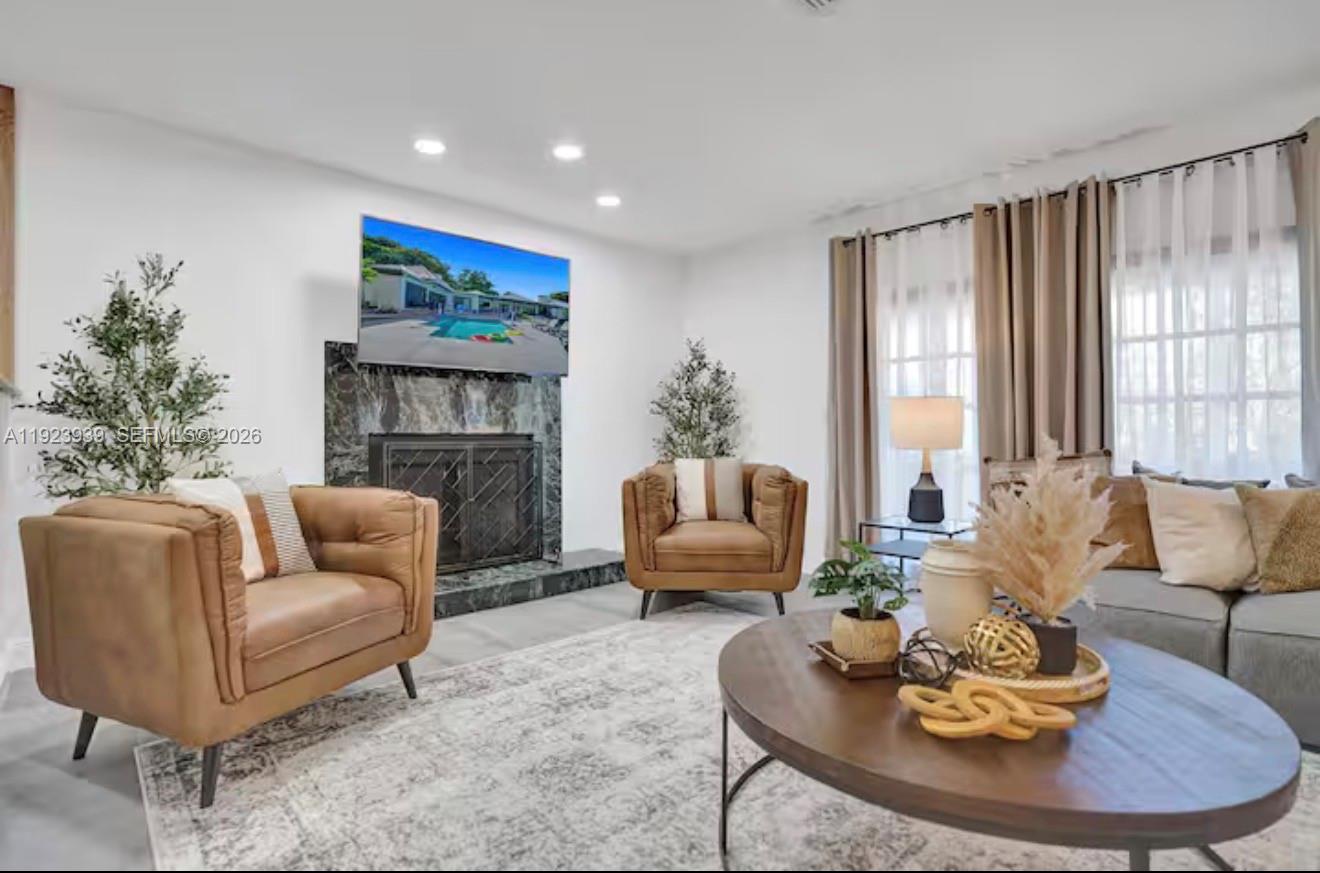 11155 Southwest 40th Street Davie, FL 33328 - Photo 6 of 100 a living room with furniture and a fireplace