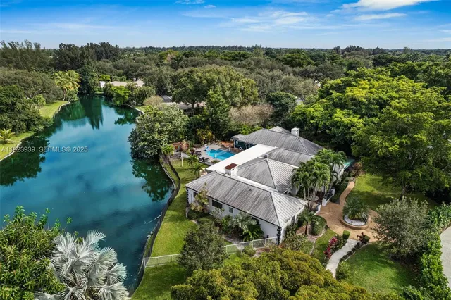 a dining room with furniture and a potted plant