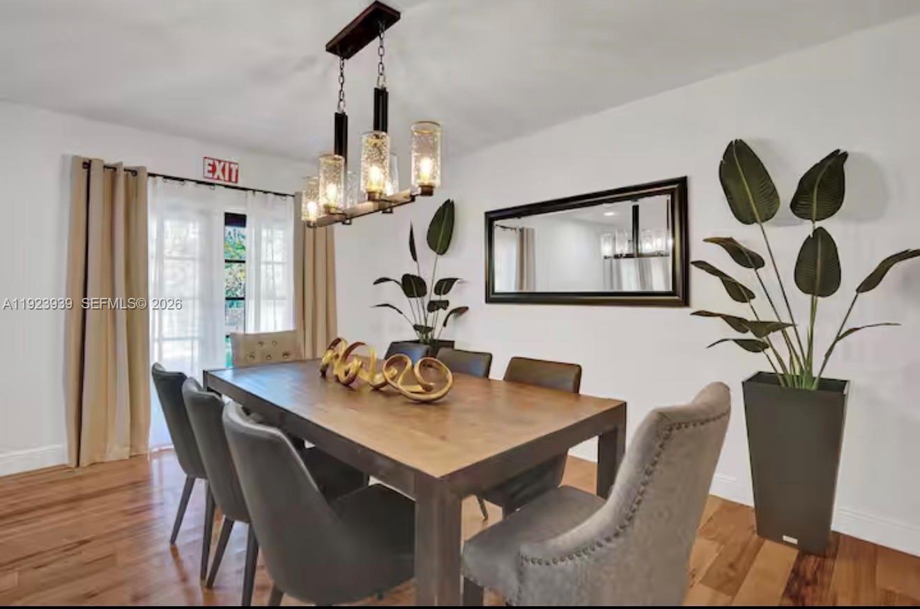 11155 Southwest 40th Street Davie, FL 33328 - Photo 7 of 100 a view of a dining room with furniture and wooden floor
