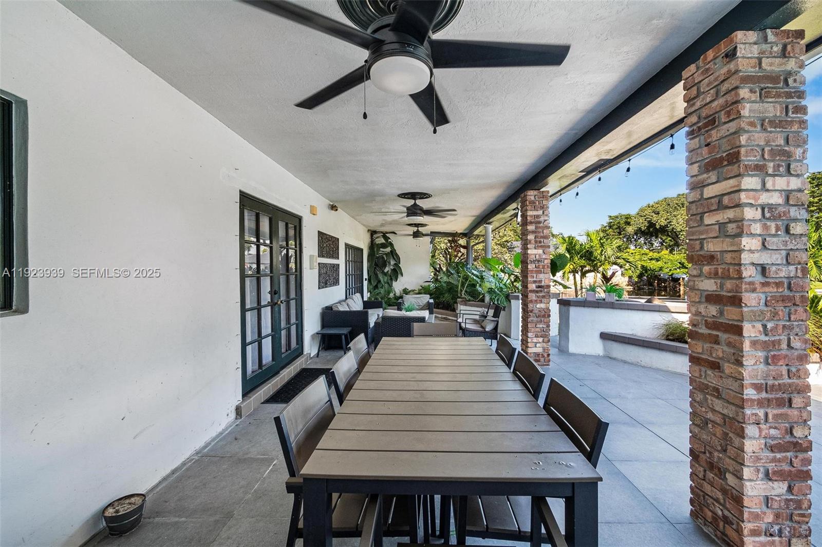 11155 Southwest 40th Street Davie, FL 33328 - Photo 10 of 74 a dining room with furniture and a potted plant