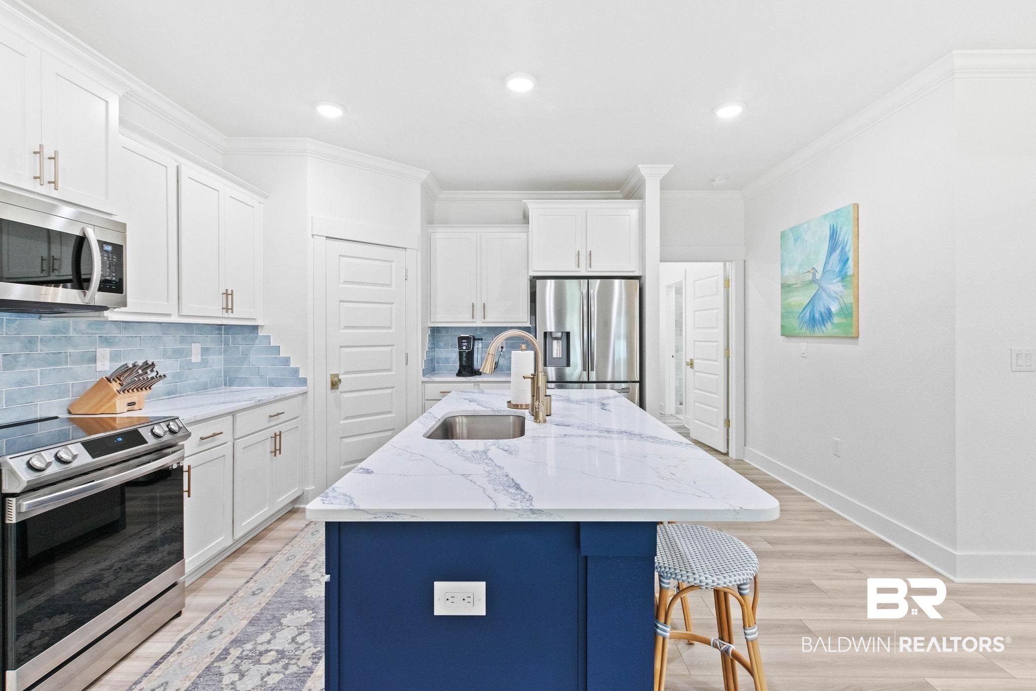 9815 Lakeview Drive Foley, AL 36535 - Photo 23 of 100 Kitchen with decorative backsplash, light hardwood / wood-style flooring, white cabinetry, stainless steel appliances, and sink
