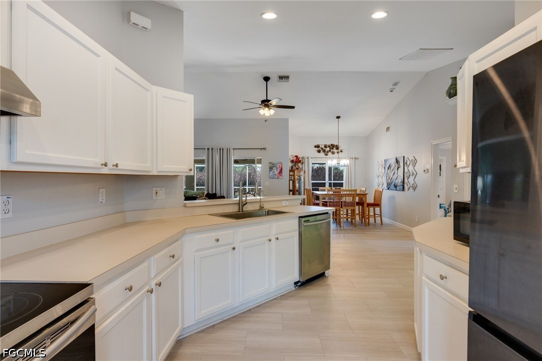 3801 28th Street Southwest Lehigh Acres, FL 33976 - Photo 12 of 37 a large white kitchen with cabinets a sink and a stove