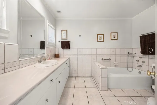 a bathroom with a sink a toilet a mirror and bathtub