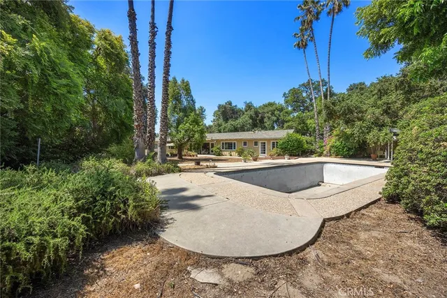 a view of a swimming pool with a yard