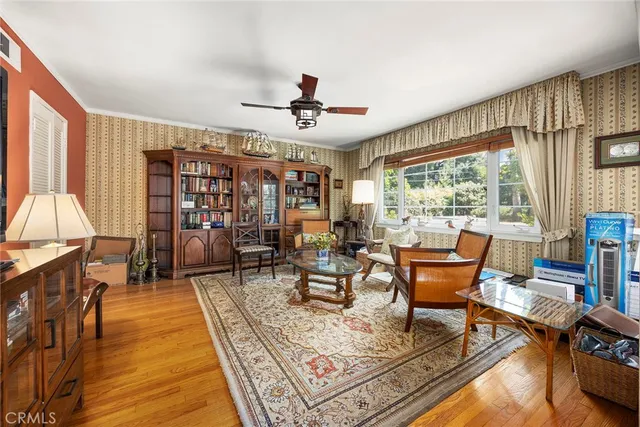 a living room with furniture a fireplace and large windows